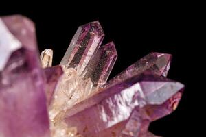 Macro of amethyst mineral stone on black background photo