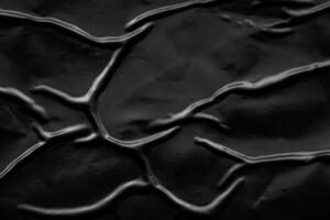 black crumpled and creased plastic poster texture background photo