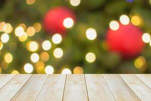 Empty wood table top with blur Christmas tree with bokeh light background photo