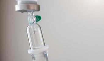 Close up medical intravenous IV drip in hospital background photo