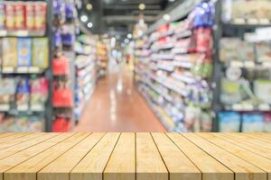 Empty wood table top with supermarket blurred background for product display photo