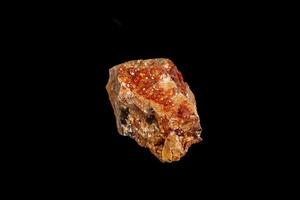 Macro mineral stone Vanadinite on a black background photo