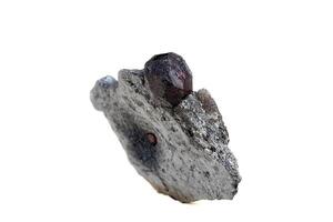 Macro mineral stone garnet  in the rock on a white background photo