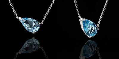 beautiful pendant aquamarine in gold with a chain on a black background photo