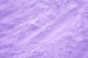 Transparent clear purple liquid serum gel cosmetic texture background photo