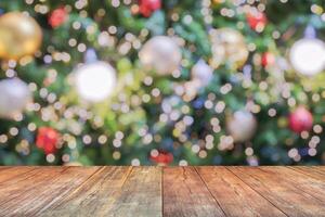 Empty wood table top with blur Christmas tree with bokeh light background photo