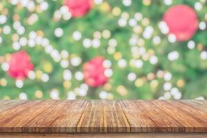 Empty wood table top with blur Christmas tree with bokeh light background photo