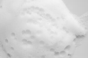 Abstract white soap foam bubbles texture background photo