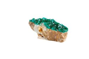 Macro mineral stone Dioptase silicate copper on a white background photo