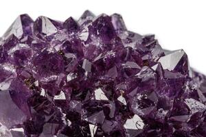 Macro mineral stone Amethysts eye crystals on white background photo