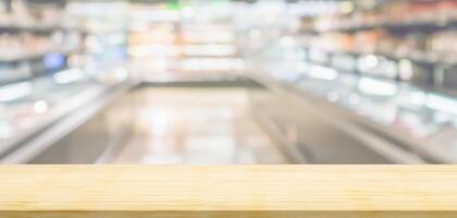 Empty wood table top with supermarket blurred background for product display photo