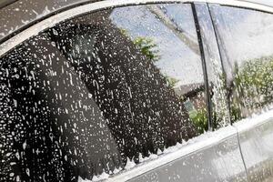 car cleaning and washing with foam soap photo