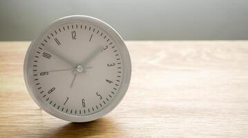 Silver alarm clock on wood table background photo