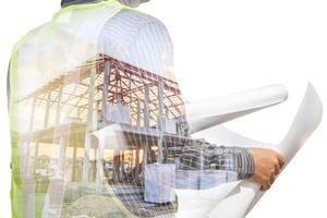 Double exposure image of professional engineer in protective helmet and blueprints paper at building construction site photo