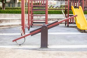 Empty wooden seesaw at the playground photo