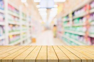 Empty wood table top with supermarket blurred background for product display photo