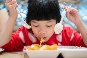 Cute little asian child girl eating food photo