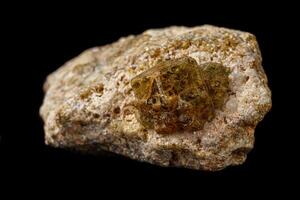 Macro stone Grossular mineral on a black background photo