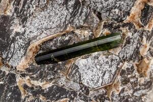 Macro stone tourmaline mineral on a black background photo