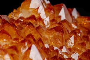 Macro mineral stone Citrine in rock in crystals on a black background photo