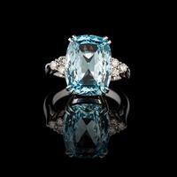 Beautiful gold ring with aquamarine and diamonds on a black background photo