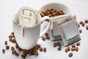 Drip coffee bag with ground coffee in  cup photo