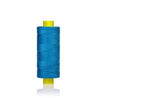 a skein of threads of blue color macro on a white background photo