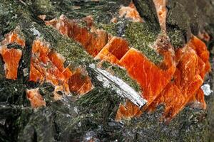 Macro stone mineral Diopside Calcite Magnetite on a white background photo
