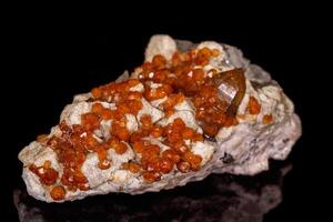 macro mineral stone Grossular, Garnet, Epidote on a black background photo