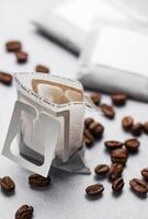 Drip coffee paper bags with coffee beans photo