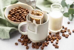 Drip coffee bag with ground coffee in  cup photo