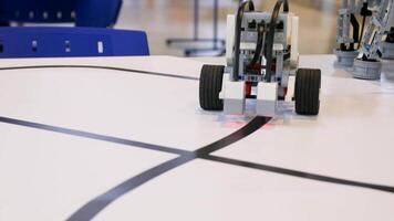 New robot project. Driving over the black tape. Self control with path detector. Electric vehicle robot on wheels during the race video