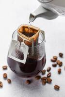 Drip Coffee Bag in a Glass Cup photo