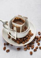 Drip coffee bag with ground coffee in  cup photo