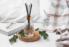 Aromatic reed air freshener, eucalyptus leaves and candle photo