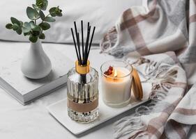 Aromatic reed air freshener, eucalyptus leaves and candle photo
