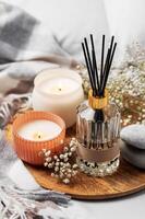 Cozy home atmosphere. Home liquid fragrance in glass bottle photo