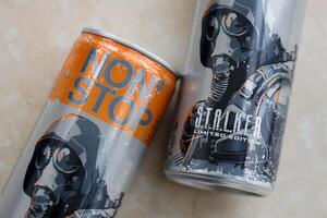 KYIV, UKRAINE - OCTOBER 31, 2023 Non Stop energy drink with limited edition design of Stalker and character with gas mask on aluminium tin can photo