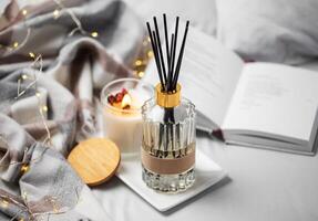 Cozy home atmosphere. Home liquid fragrance in glass bottle photo