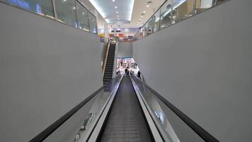 Thailand, Bangkok June 10 2017. Escalator in mall first person view. Escalator for scroll down to the floor of a shopping mall. video