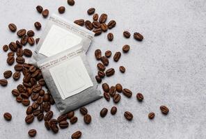 Drip coffee paper bags with coffee beans photo