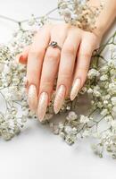 Hand of a young woman with white pearl  manicure photo