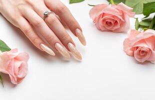 Female Hands on a white background with beautiful pearl manicure photo