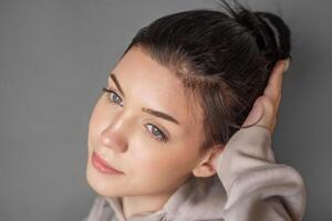 Portrait of a young pretty girl in a  hoodie photo