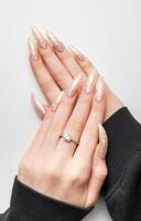 Manicured nails with pearlescent nail polish photo