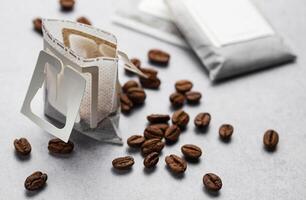 Drip coffee paper bags with coffee beans photo