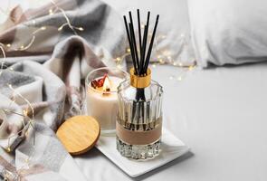 Cozy home atmosphere. Home liquid fragrance in glass bottle photo