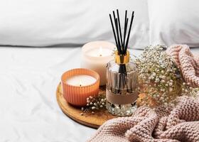 Cozy home atmosphere. Home liquid fragrance in glass bottle photo