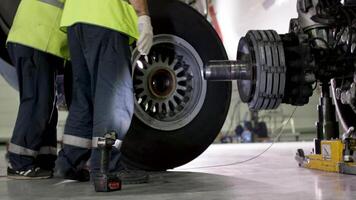 Airport worker checking chassis. Engine and chassis of the passenger airplane under heavy maintenance. Engineer checks the aircraft chassis and engine. video