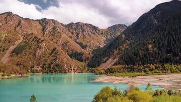 Idyllic summer landscape with clear mountain lake. Stock. Mountain lake landscape. View of the Sunny mountain valley with lakes and rivers video